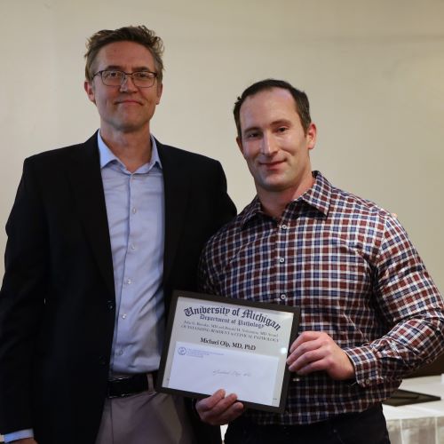 Dr. Lee Schroeder presents Dr. Michael Olp with the John Batsakis & Ronald Nishiyama Outstanding CP Resident Award.